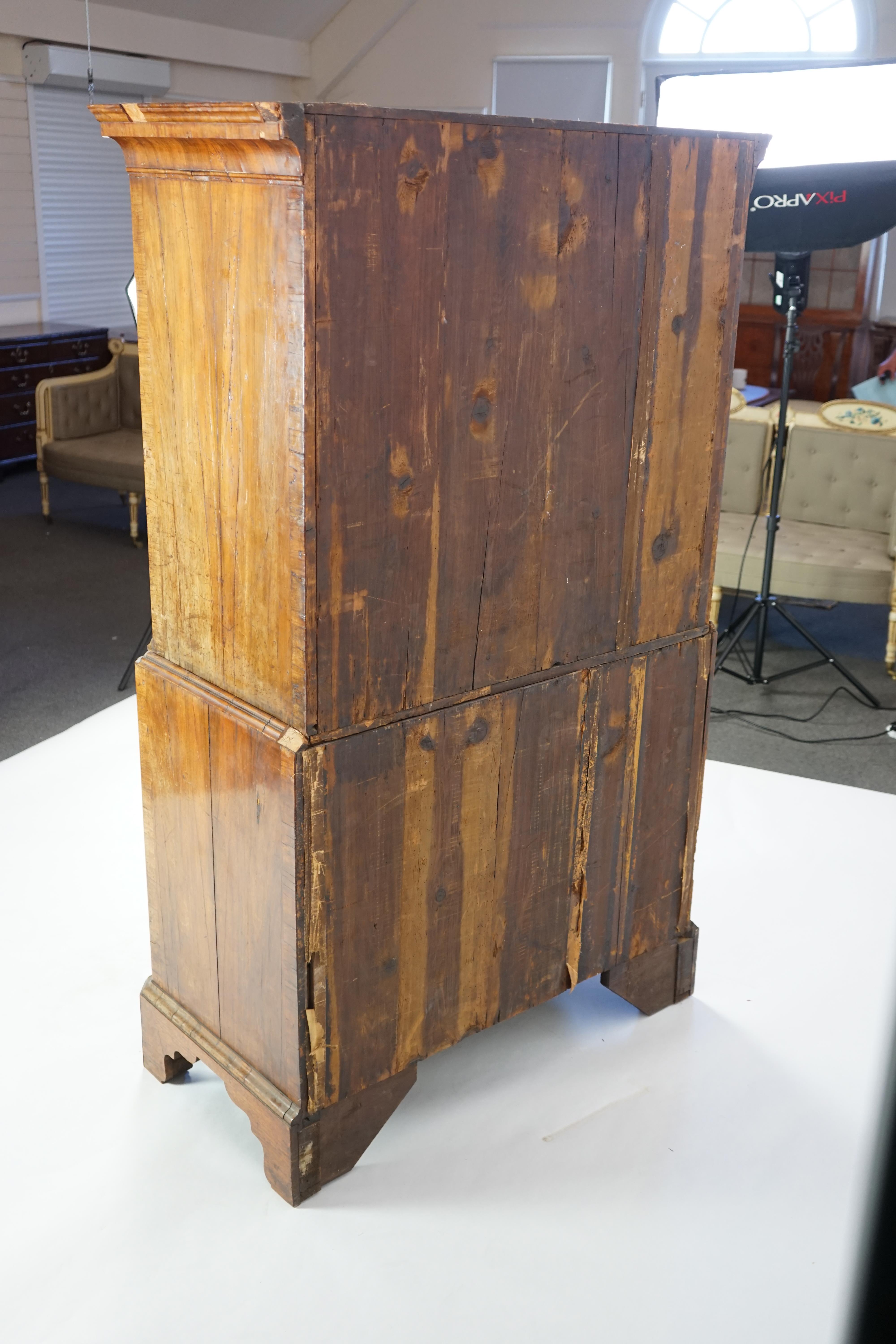 A George II feather banded walnut chest on chest